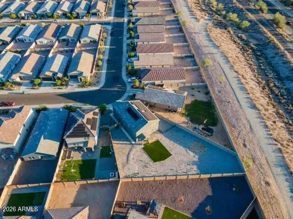 an aerial view of residential houses with yard