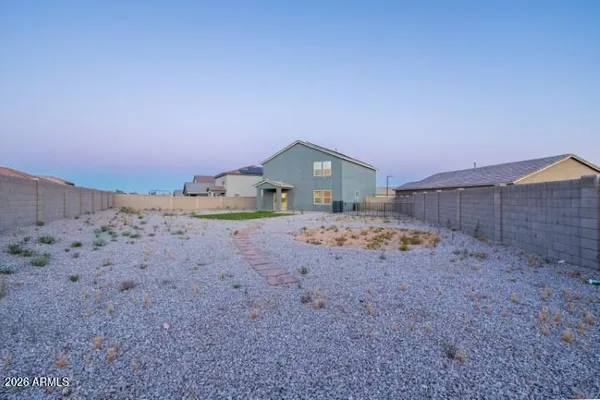 a view of back yard and front view of a house