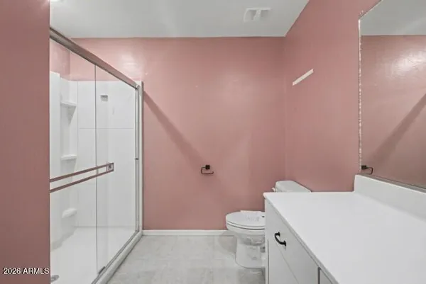 a white toilet sitting next to a bathroom sink