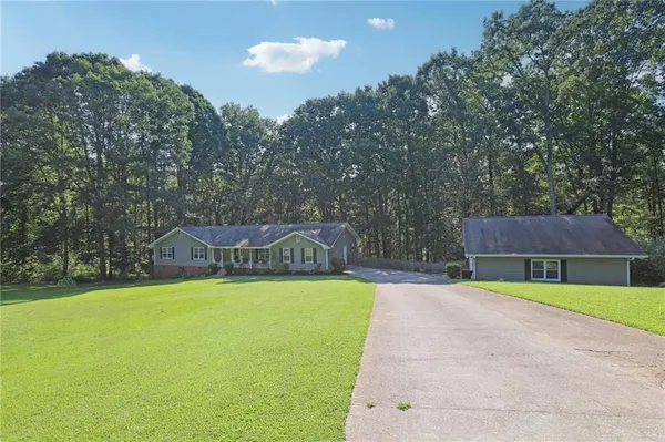 a view of a swimming pool with a yard and trees