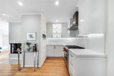 a kitchen that has a sink and a stove in it