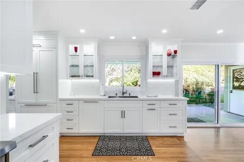 a kitchen with granite countertop a sink and cabinets