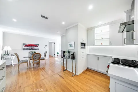 a living room with furniture a table and wooden floor