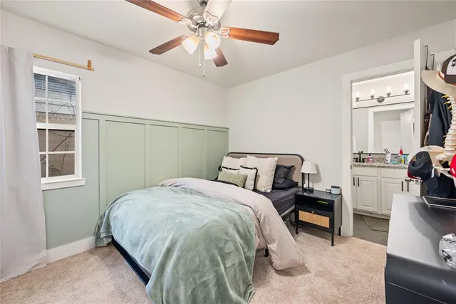 a bed room with a bed and a chandelier