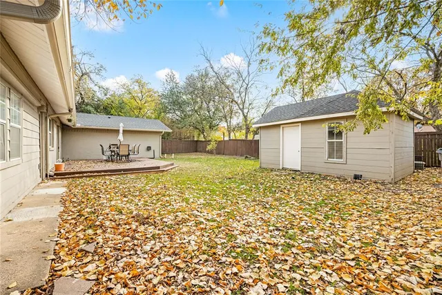 a front view of a house with a garden and yard