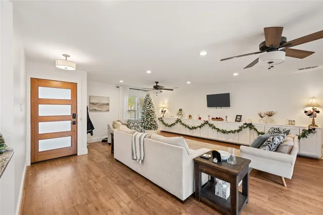 a living room with furniture and wooden floor
