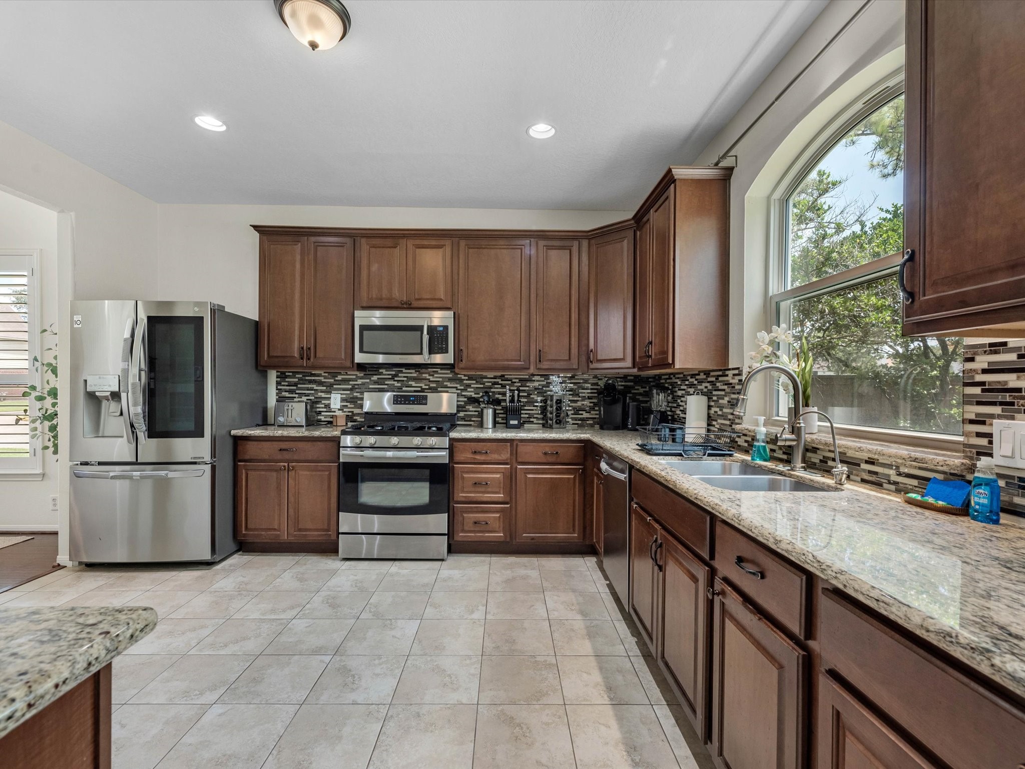 14003 Stardust Lane Houston, TX 77041 - Photo 13 of 30 a kitchen with a sink stove and refrigerator