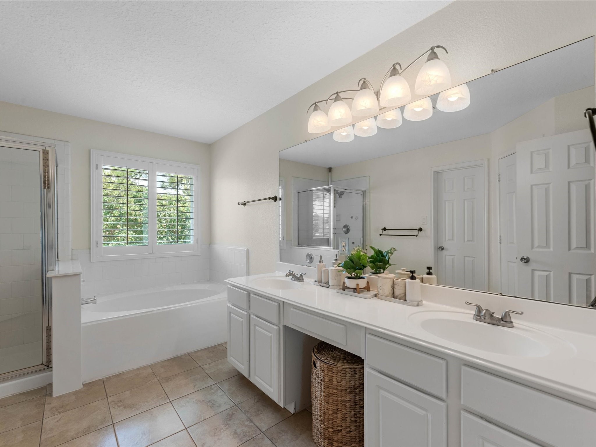 14003 Stardust Lane Houston, TX 77041 - Photo 21 of 30 a bathroom with a sink double vanity mirror and a bathtub