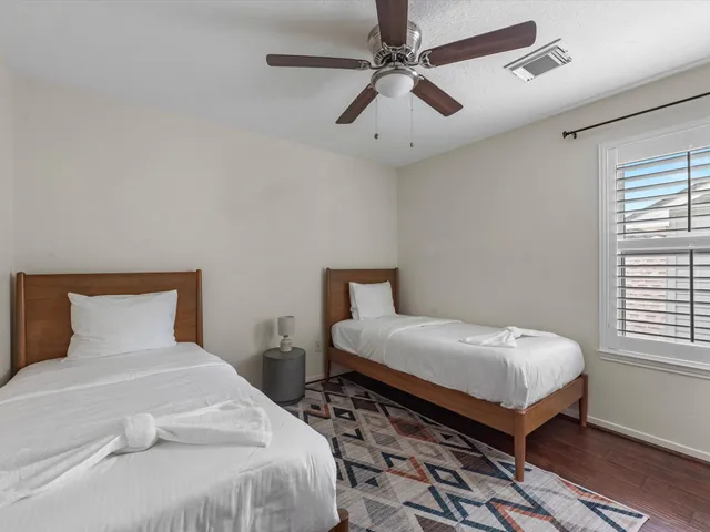 a bedroom with a bed and a window