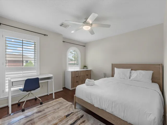 a bedroom with a bed and a window