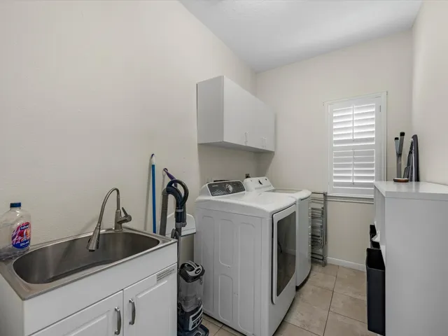 a utility room with sink dryer and washer