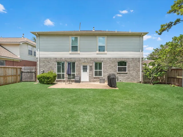 a view of a house with backyard sitting area and garden