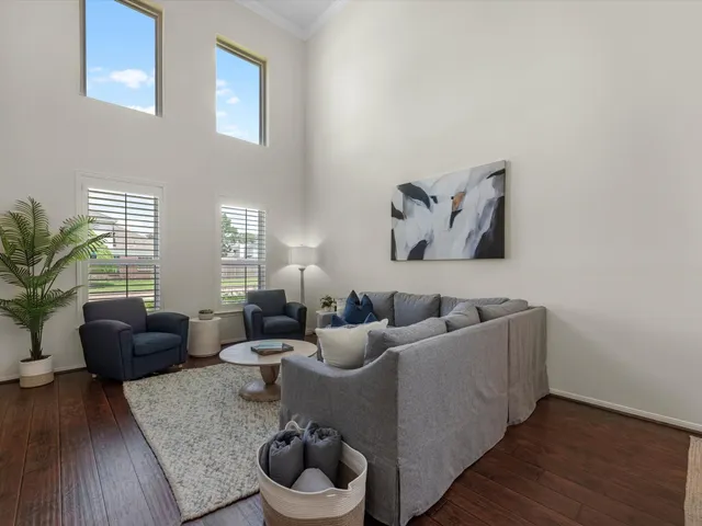 a living room with furniture and wooden floor