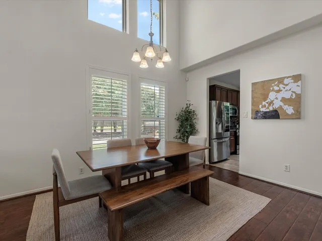 a living room with furniture a chandelier and a table