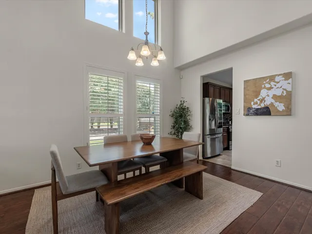a living room with furniture a chandelier and a table