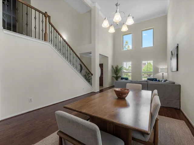 a view of a dining room with furniture and a chandelier