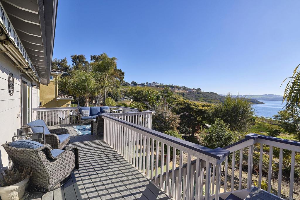 4235 Harrison Street Carlsbad, CA 92008 - Photo 15 of 55 a view of a balcony with couches and wooden floor