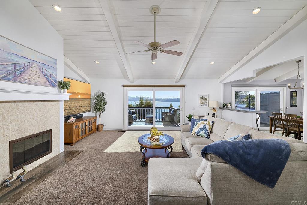 4235 Harrison Street Carlsbad, CA 92008 - Photo 3 of 55 a living room with furniture a fireplace and a chandelier