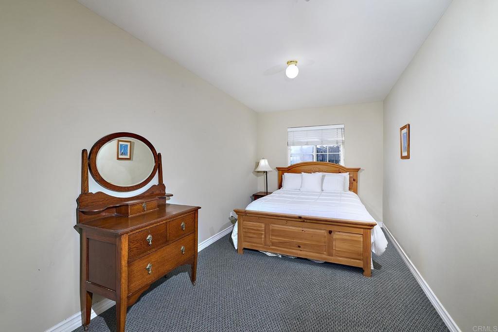 4235 Harrison Street Carlsbad, CA 92008 - Photo 32 of 55 a living room with furniture a mirror and a window