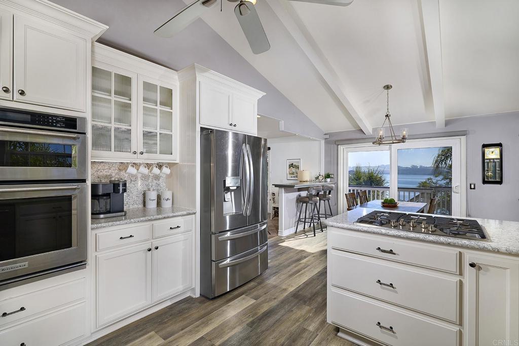 4235 Harrison Street Carlsbad, CA 92008 - Photo 9 of 55 a kitchen with a refrigerator and a stove top oven