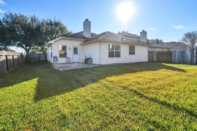 a front view of a house with a yard and lake view