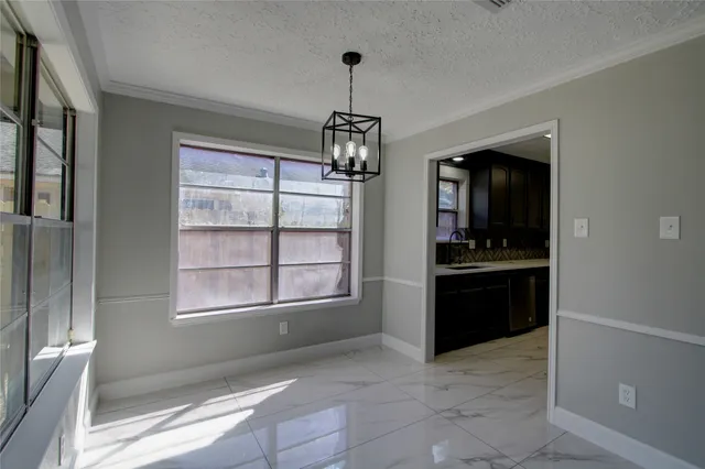 a kitchen with sink and refrigerator