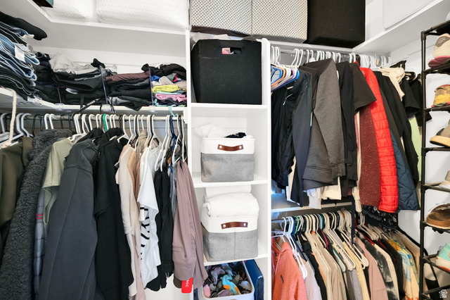 7713 Navarro View Court Midvale, UT 84047 - Photo 18 of 41 Custom closet system featuring multiple hanging rods, integrated shelving, and dedicated shoe storage