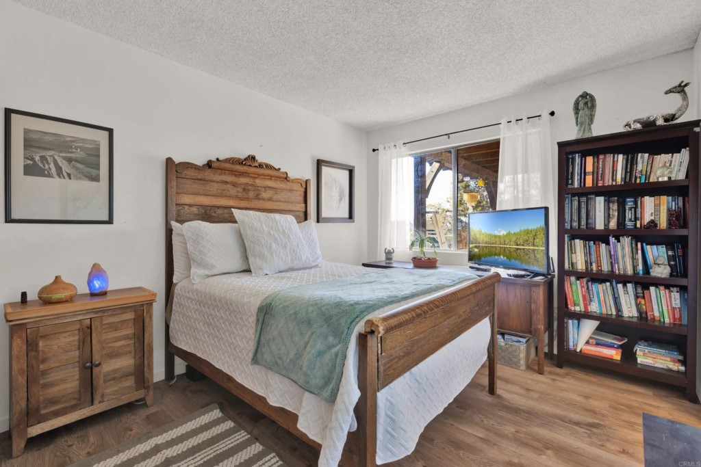 15866 Lyons Valley Road Jamul, CA 91935 - Photo 28 of 56 a bedroom with a bed and a book shelf