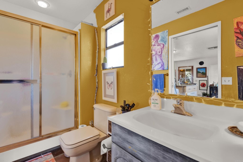 15866 Lyons Valley Road Jamul, CA 91935 - Photo 47 of 56 a bathroom with a sink a toilet a mirror and shower