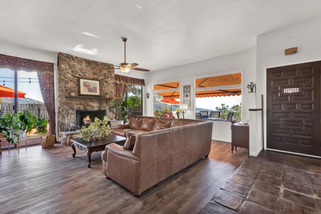 15866 Lyons Valley Road Jamul, CA 91935 - Photo 9 of 56 a living room with furniture a fireplace and potted plants