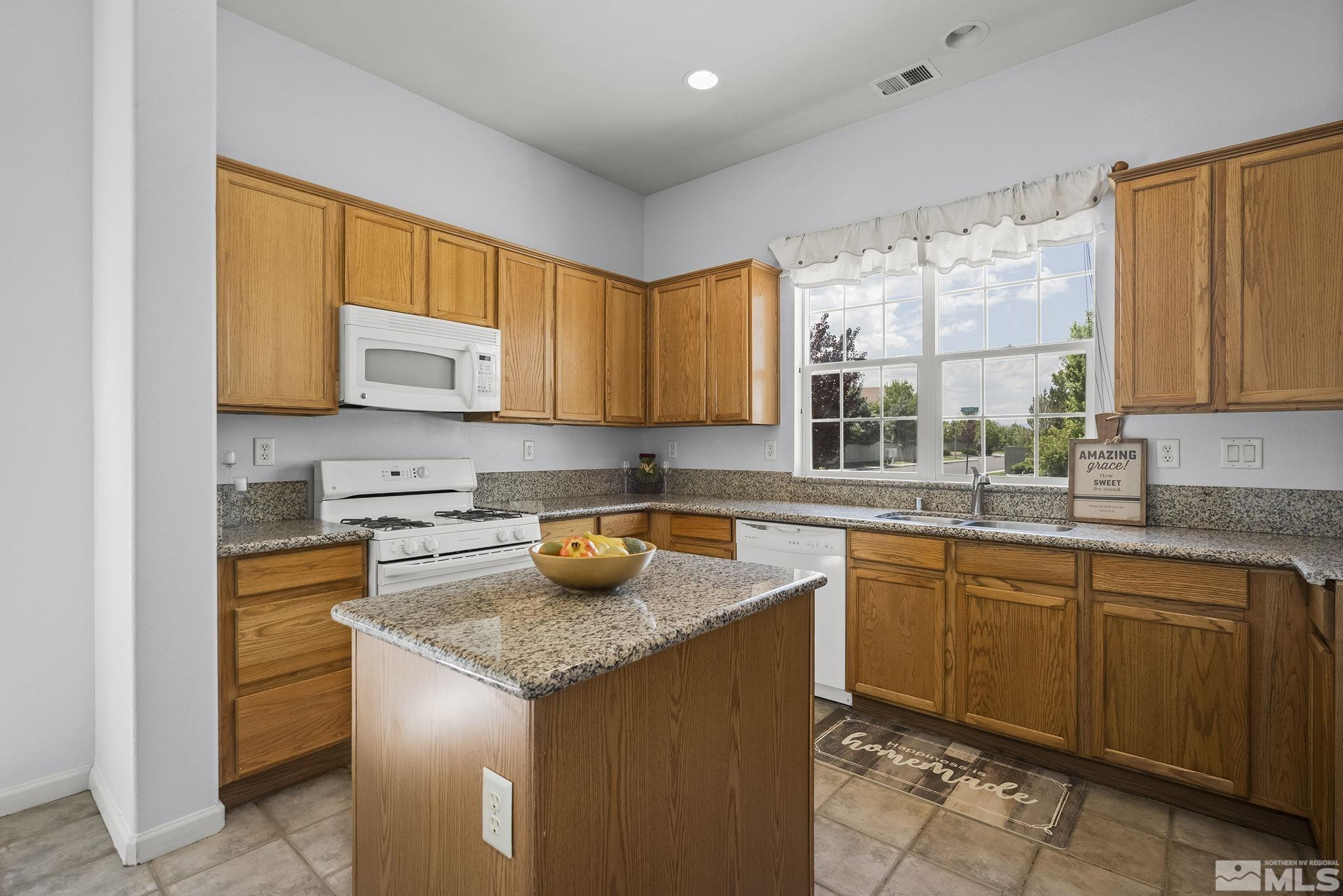 10160 Buckeye Court Reno, NV 89521 - Photo 11 of 36 a kitchen with a sink a stove and cabinets