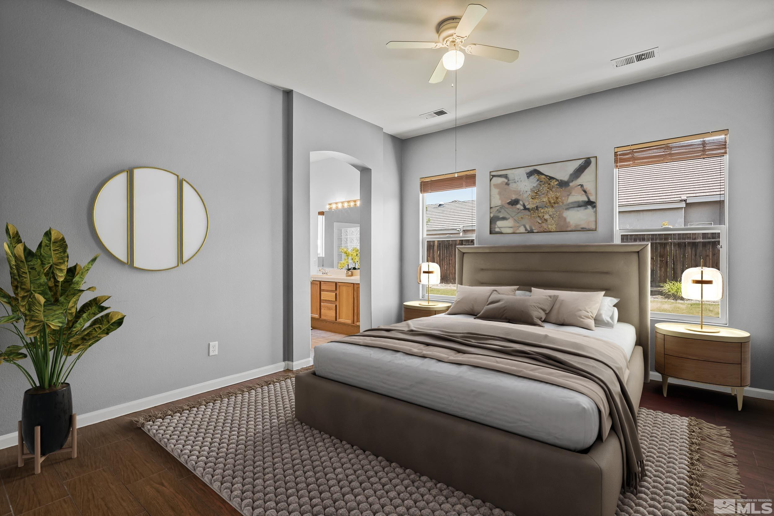 10160 Buckeye Court Reno, NV 89521 - Photo 14 of 36 a bedroom with a large bed and a chandelier