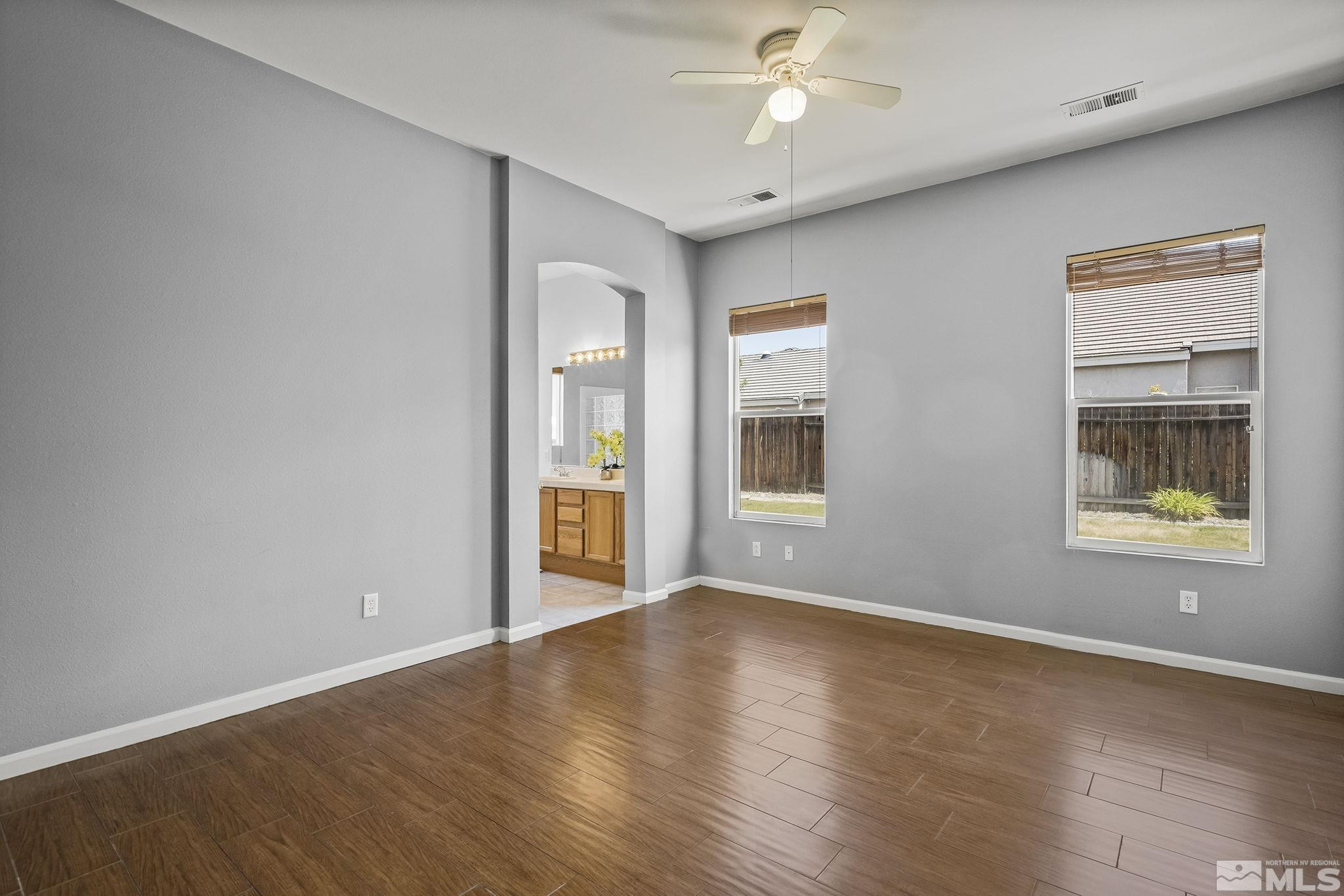 10160 Buckeye Court Reno, NV 89521 - Photo 15 of 36 an empty room with wooden floor and windows