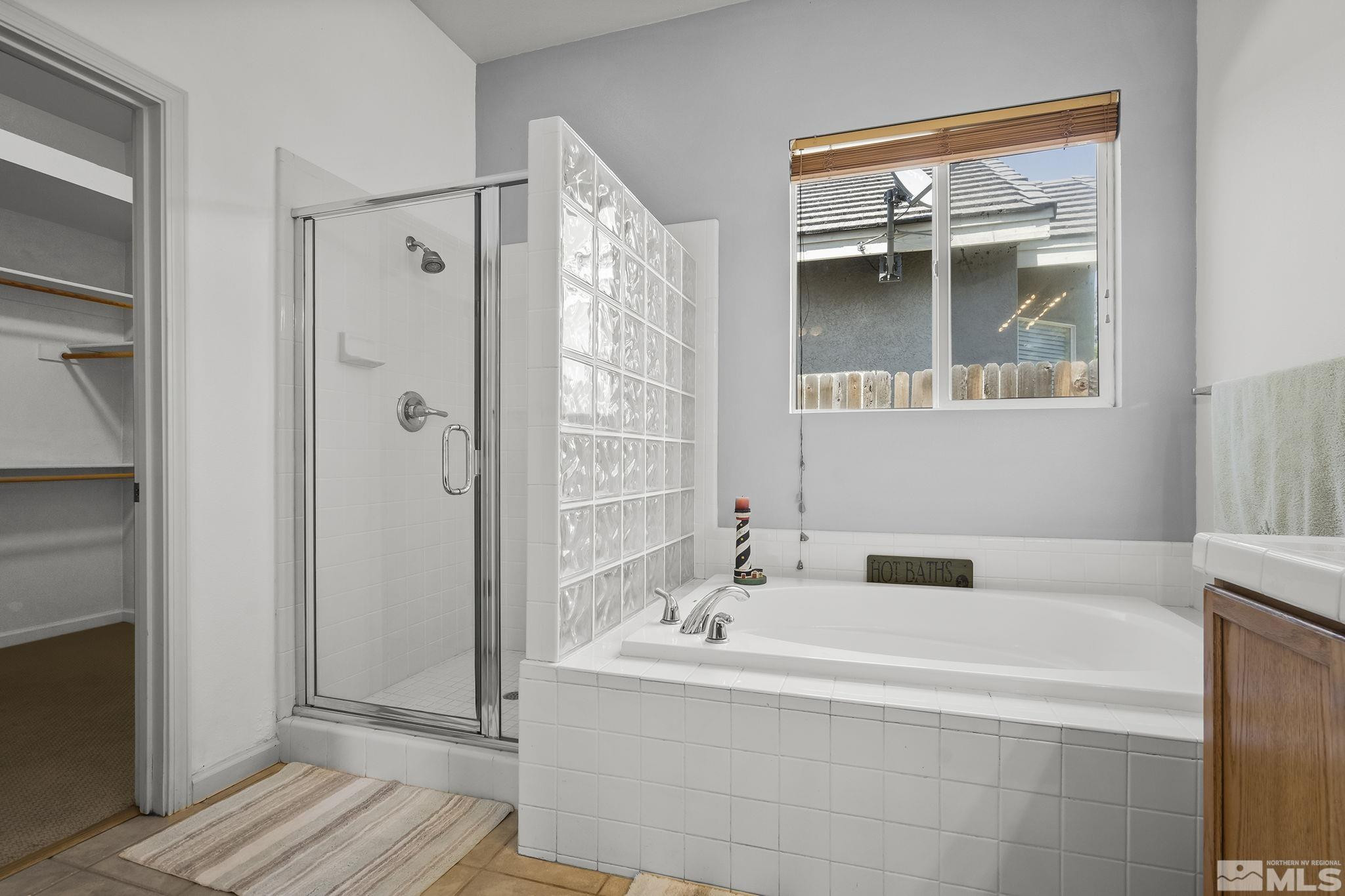 10160 Buckeye Court Reno, NV 89521 - Photo 18 of 36 a bathroom with a bathtub and a shower