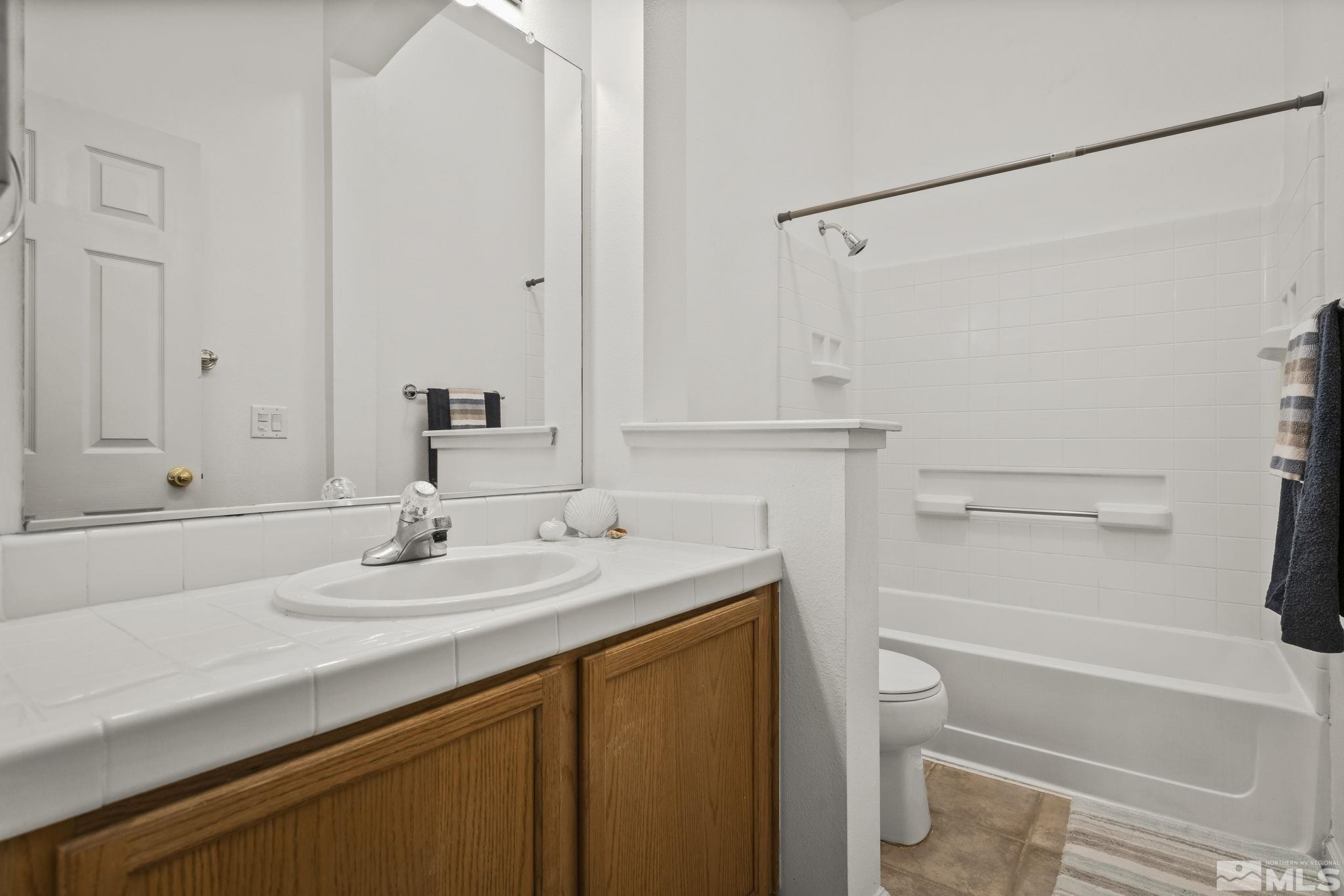 10160 Buckeye Court Reno, NV 89521 - Photo 23 of 36 a bathroom with a sink toilet vanity and tub
