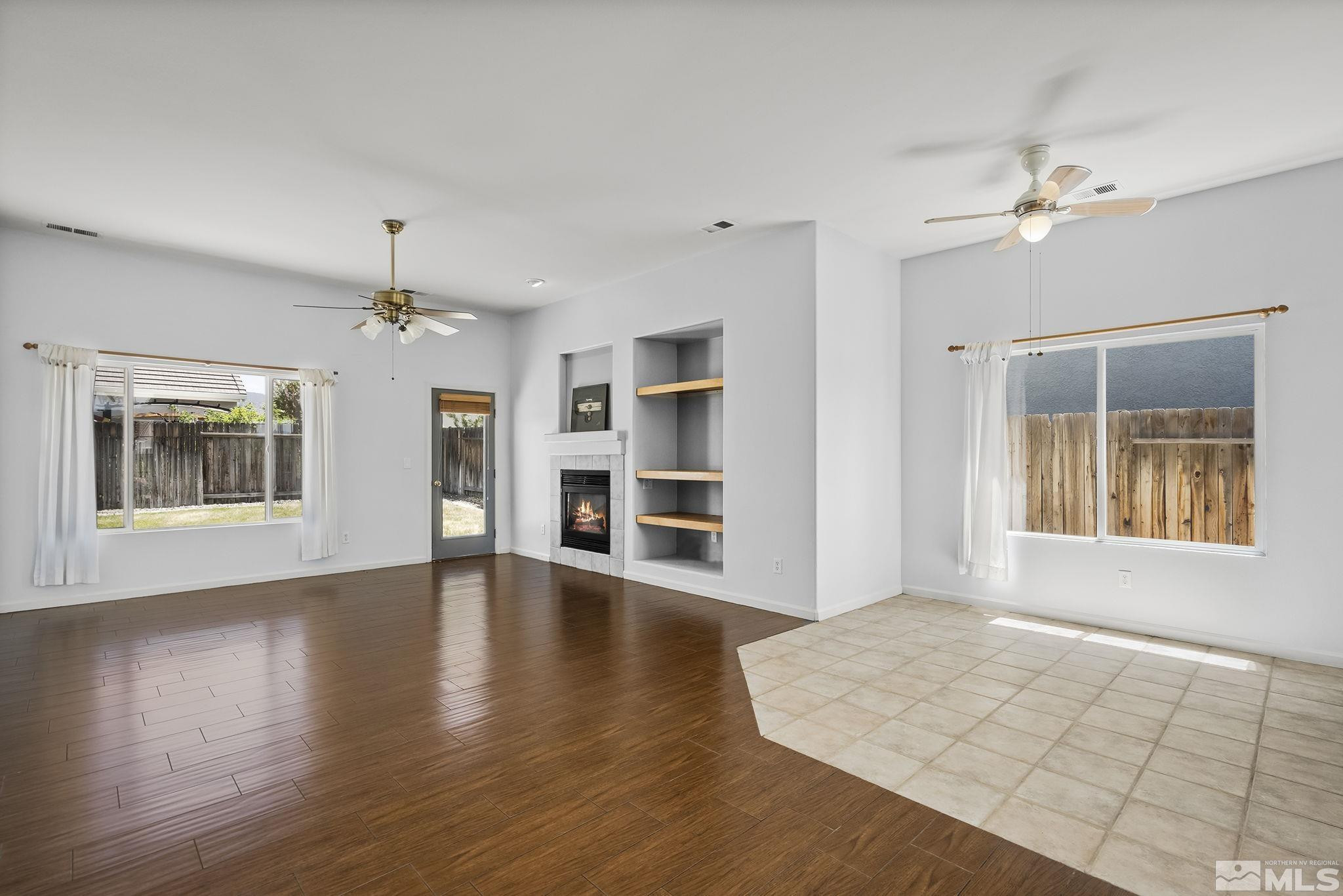 10160 Buckeye Court Reno, NV 89521 - Photo 3 of 36 a view of an empty room with a window and wooden floor