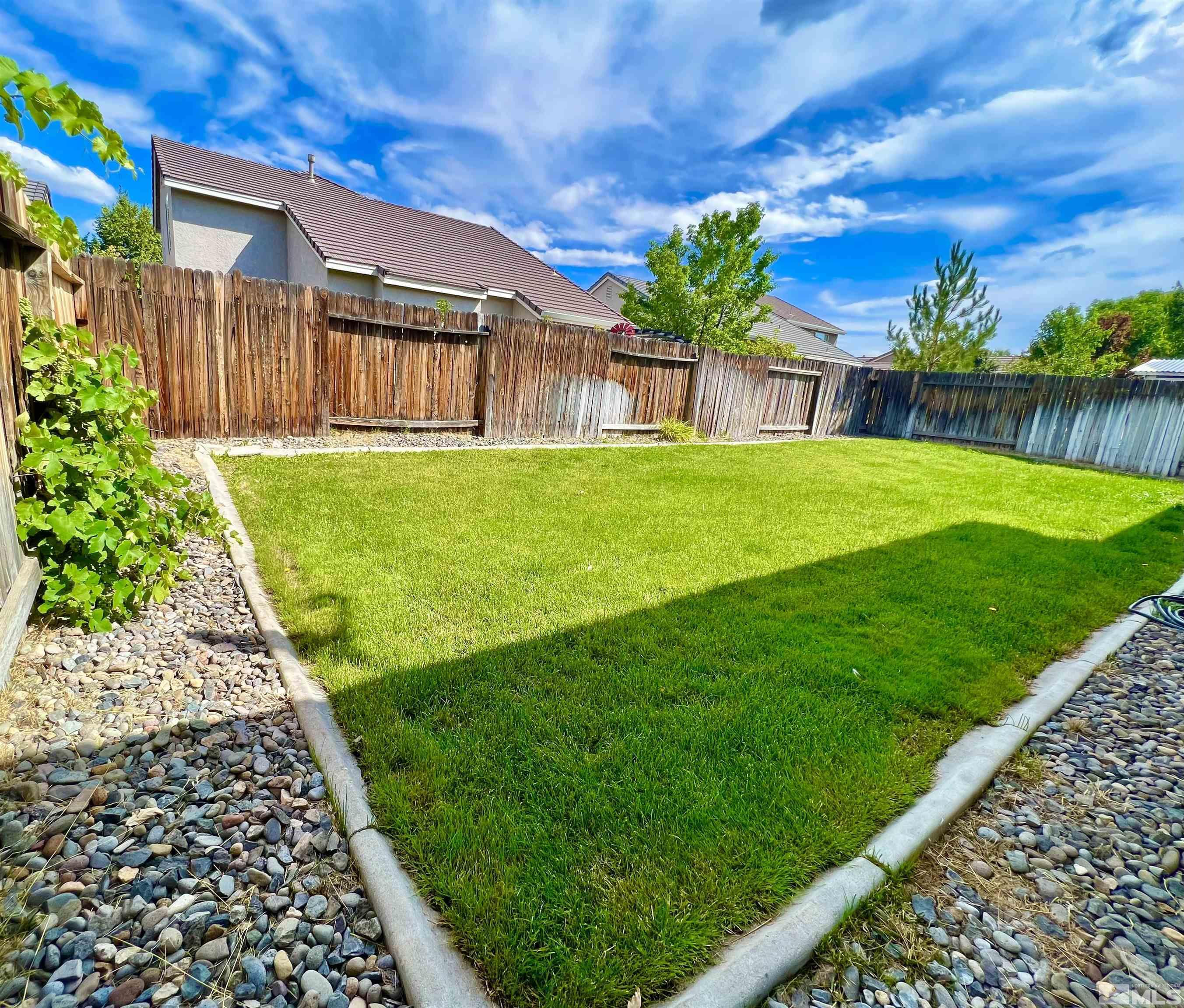10160 Buckeye Court Reno, NV 89521 - Photo 34 of 36 a view of a brick house with a yard