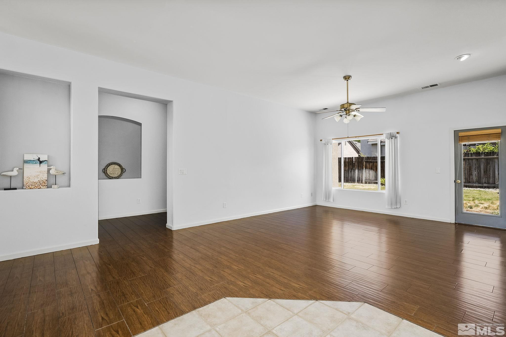 10160 Buckeye Court Reno, NV 89521 - Photo 6 of 36 a view of an empty room with window and wooden floor