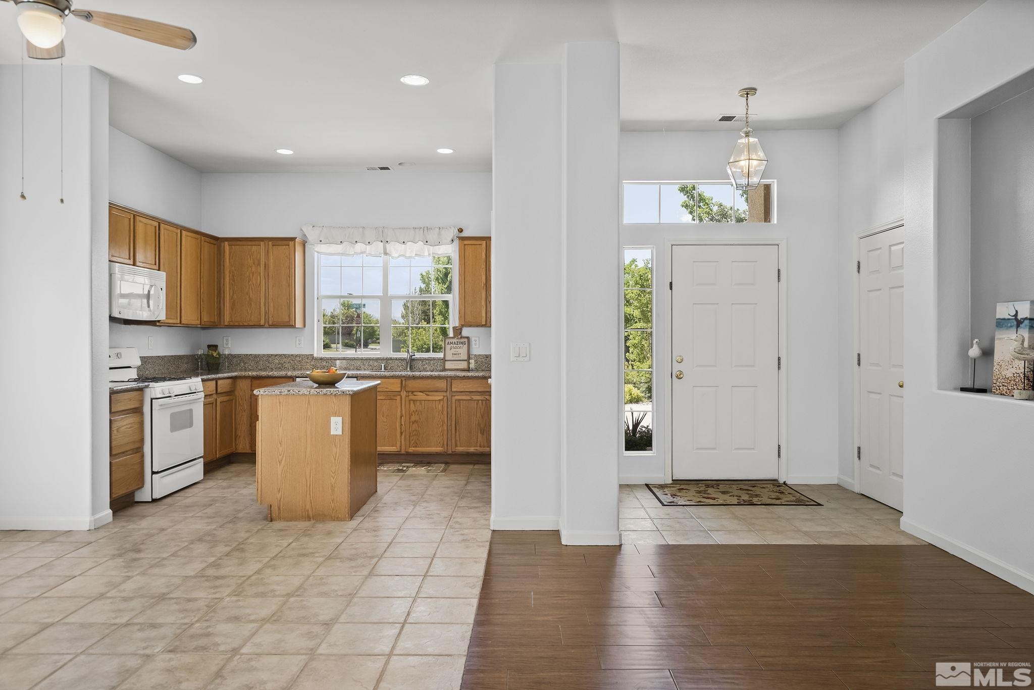 10160 Buckeye Court Reno, NV 89521 - Photo 8 of 36 a kitchen with a refrigerator and a stove top oven