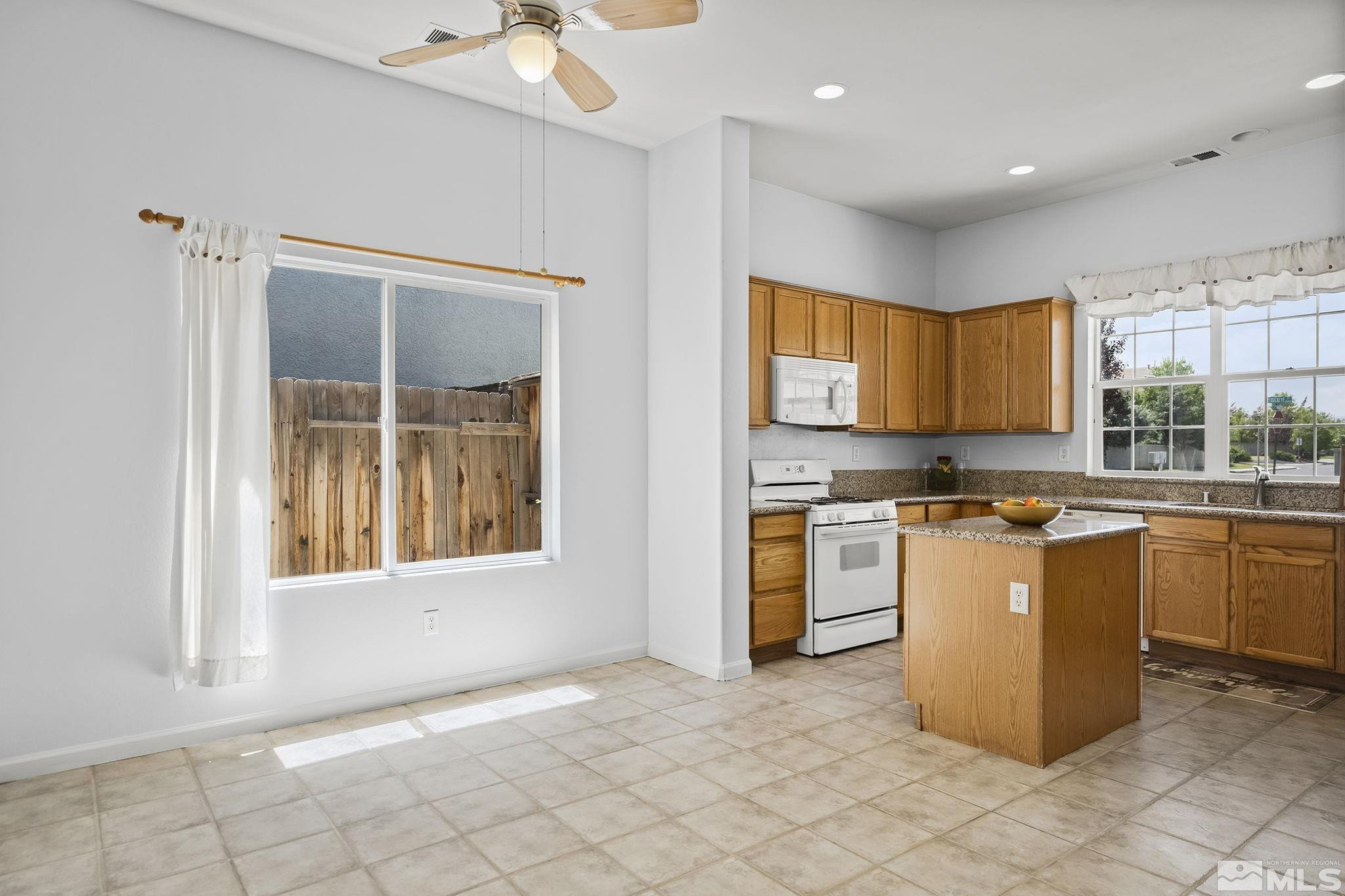 10160 Buckeye Court Reno, NV 89521 - Photo 9 of 36 a kitchen with a stove a sink and a refrigerator