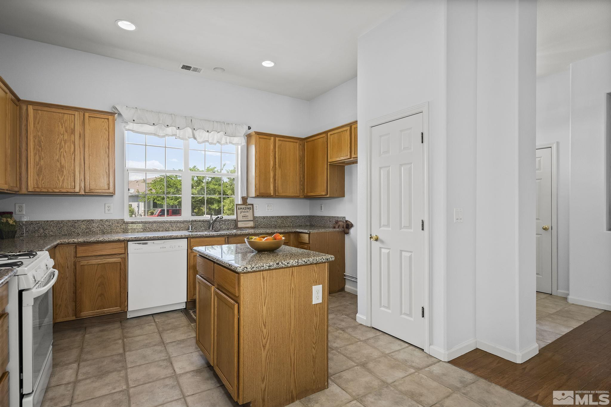 10160 Buckeye Court Reno, NV 89521 - Photo 10 of 36 a kitchen with a sink stove and cabinets
