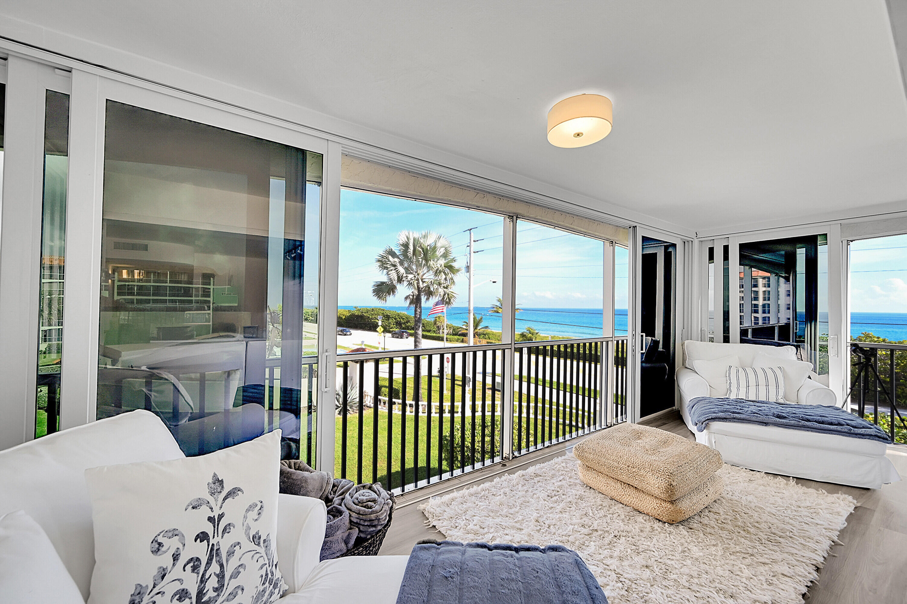 2871 North Ocean Boulevard, Unit D302 Boca Raton, FL 33431 - Photo 3 of 59 a bedroom with a bed and a large window with outer view