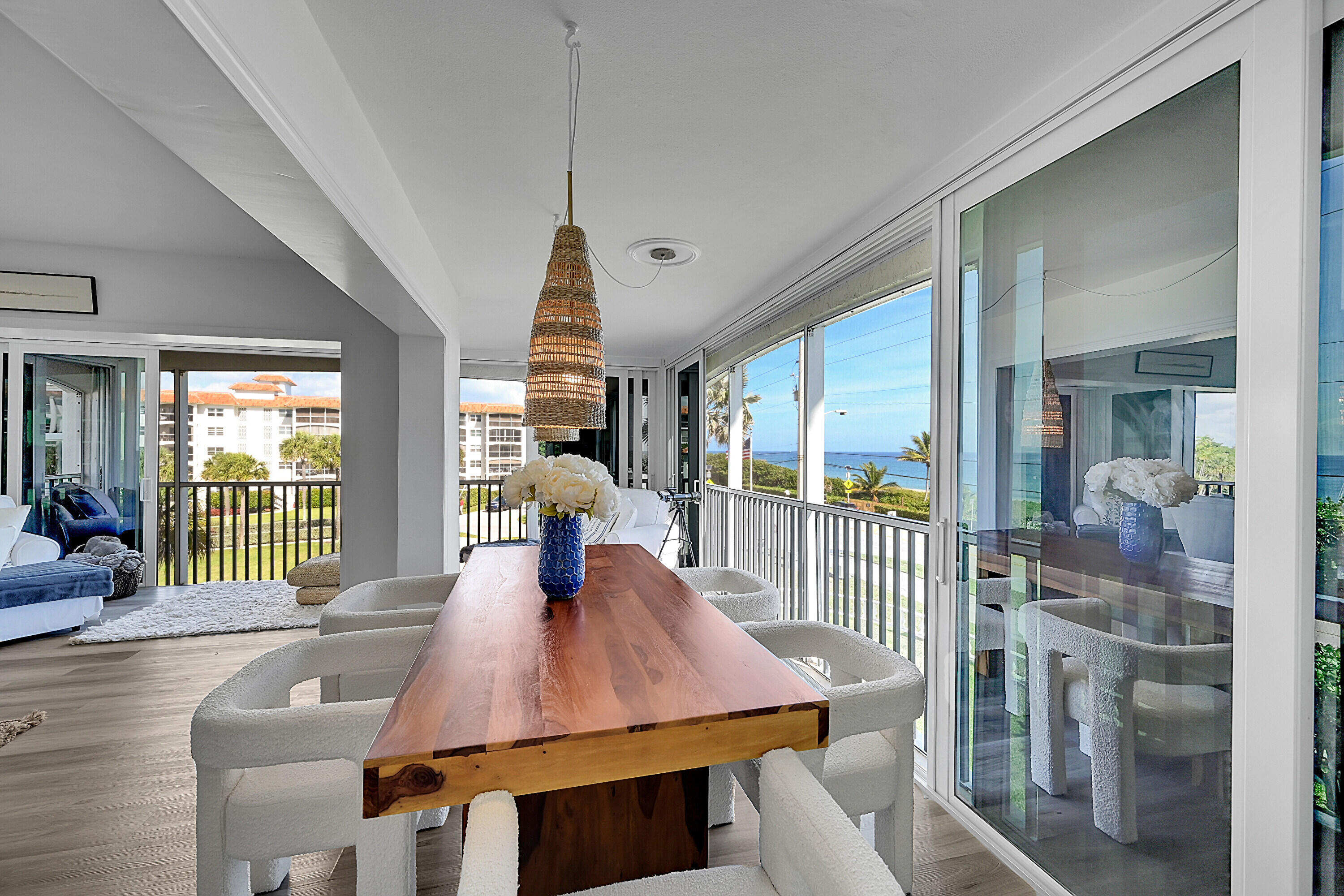 2871 North Ocean Boulevard, Unit D302 Boca Raton, FL 33431 - Photo 10 of 59 a view of a dining room with furniture window and wooden floor