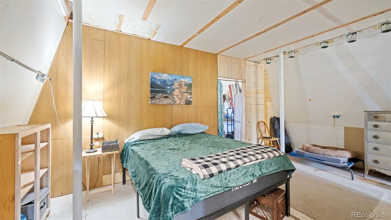 2904 Siloam Road Pueblo, CO 81005 - Photo 26 of 34 a bedroom with a bed and a table