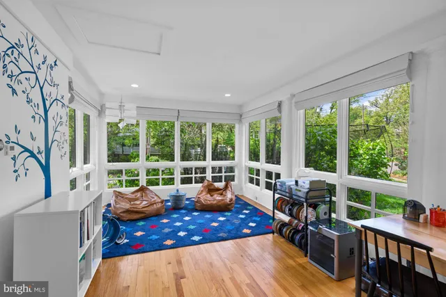 a living room with furniture and large windows