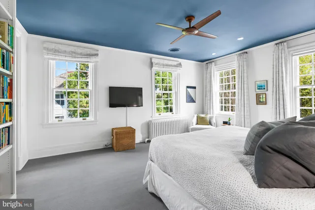 a bedroom with a bed furniture and flat screen tv