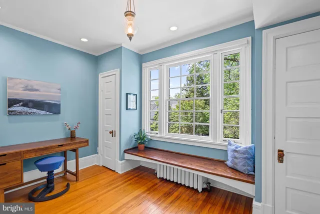 a bedroom with furniture and a window