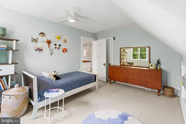 a living room with furniture and a baby crib