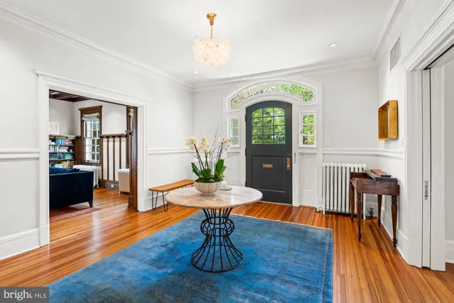 a view of a livingroom with furniture wooden floor a chandelier