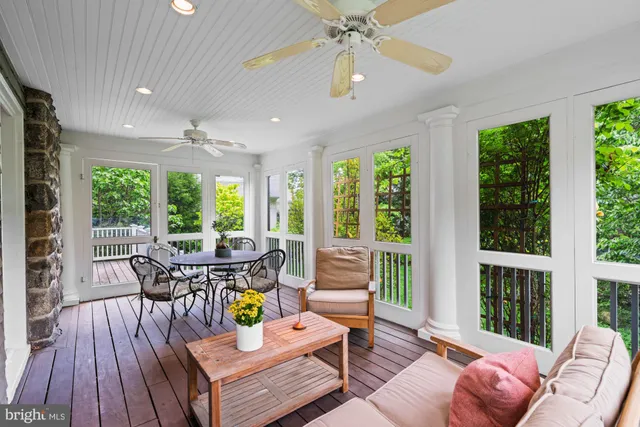 a living room with furniture and floor to ceiling windows